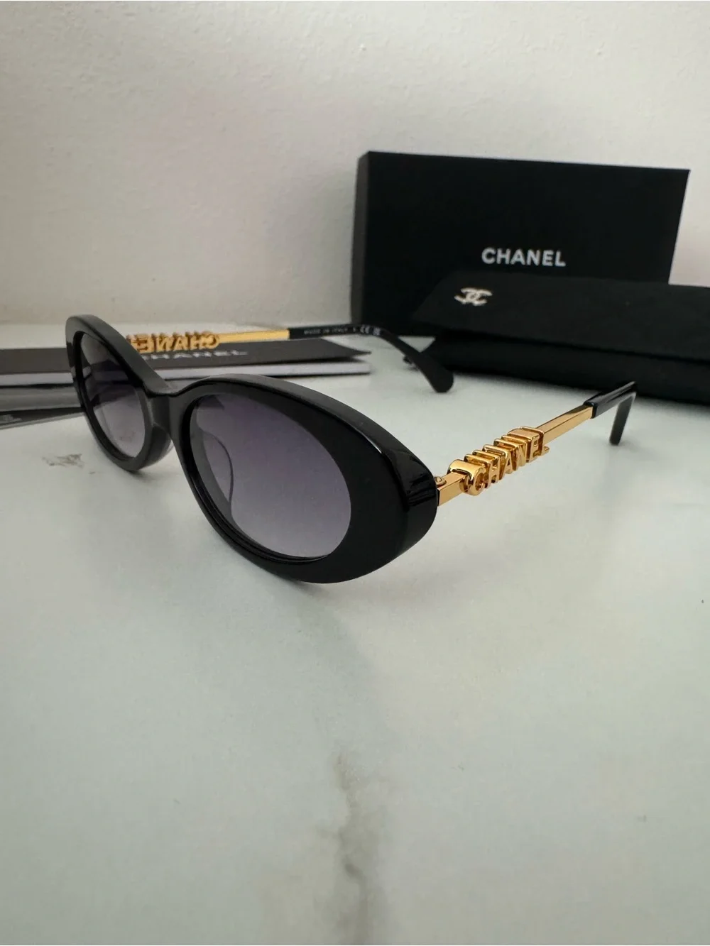 CHANEL Black Oval Sunglasses with Gray Gradient Lenses